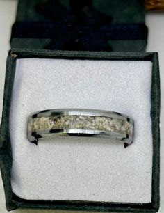 a wedding band in a box that is empty