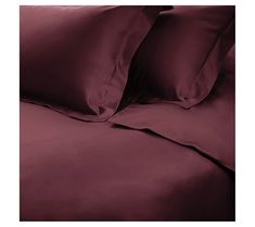 an image of a bed with maroon sheets and pillowcases on top of it