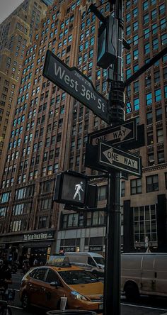 the street signs are clearly visible for everyone to see on this busy city street in new york