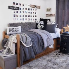 a bed room with a neatly made bed and lots of decorations on the wall above it