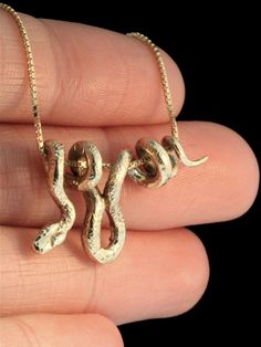 "This sinuous Vine Snake Pendant wraps gracefully along its \"vine\" chain. The detailed snake is cast in solid 14K gold, is completely three dimensional and it is 1 3/8\" long. It is pictured on a 1.1mm gold chain. A flexible, 1mm to 1.25mm chain works best with this design. This item usually ships the same or next business day. All Marty Magic Jewelry is packaged in a beautiful box, embossed with the gold foil Marty Magic dragon logo.Perfect for any occasion! Designed in Santa Cruz, California Greek Outfit, Vine Snake, Gold Snake Necklace, Serpent Jewelry, Snake Pendant, Snake Jewelry, Snake Necklace, 14k Gold Necklace