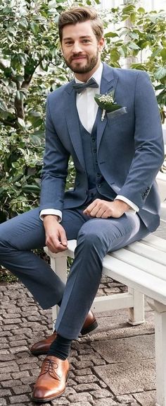 a man in a suit sitting on a bench