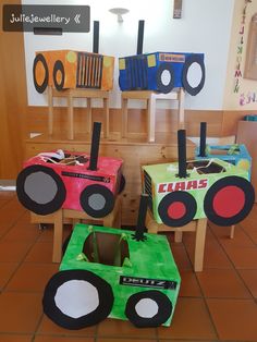 some very cute little cars made out of construction paper and cardboard boxes on the floor