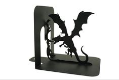 a black metal bookend with a dragon on it's back and the letter d