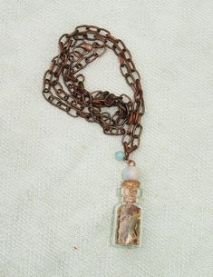 This mini glass spell bottle measures 3/4". It features herbs that correspond with Good Luck. Also, features amazonite gemstone beads. Copper necklace measures 19" length. Witch Stuff, For Good Luck, Copper Necklace, Long Pendant, Good Luck