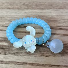 This versatile accessory can be transformed from a bracelet to a hair tie in seconds, making it a convenient and stylish choice. With its adorable Cinnamoroll design, it's perfect for fans of the beloved character. Practicality and cuteness combined in one product. Materials: elastic, plastic beads, resin Package includes: 1 hair tie Cinnamon Roll Sanrio Bracelet, Adjustable Kawaii Bracelets With Round Beads, Cinnamonroll Sanrio Jewelry, Cinnamoroll Hair Clip, Cinnamoroll Design, Cinnamon Roll Accessories Sanrio, Headband Bun, Kawaii Squishies, Bun Maker Hairstyles