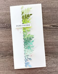 a handmade card with the words dear friend written on it and some green leaves