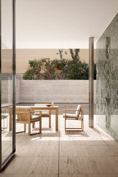 an outdoor table and chairs on a patio