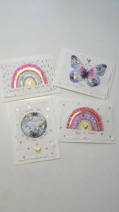 four small cards with butterflies and rainbows on them