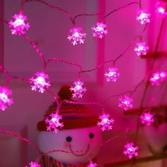 a snowman with pink lights on it's head