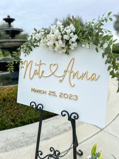 a wedding sign with flowers on it