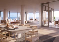 a large open living room and dining area with ocean view from the windows on the second floor