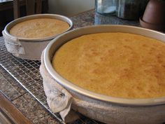 two pans filled with cake sitting on top of a counter next to each other