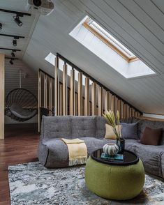 a living room filled with furniture under a skylight