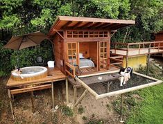 an outdoor hot tub and jacuzzi in the middle of a field with trees