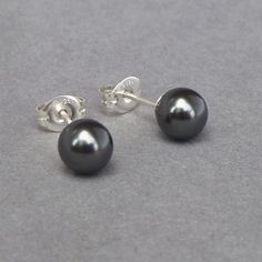 This simple pair of dark grey pearl studs have been created using 6mm black Swarovski pearls. As they come individually gift wrapped, these charcoal grey stud earrings make perfect bridal party gifts for bridesmaids. They are also perfect for wearing everyday. All of the fittings used are Sterling silver. Each pair of dark grey stud earrings are sold with butterfly backs to ensure they stay securely in place. Your jewellery will arrive gift wrapped and ready to present as a gift or a treat to yo Chunky Stone Necklace, Round Pearl Earrings, Floating Pearl Necklace, Chunky Pearl Necklace, Grey Pearl Necklace, Fused Glass Necklace, Fan Necklace, Everyday Jewellery, Jewelry King