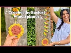 a woman holding up a crochet sunflower ornament next to a tree