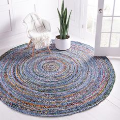 a round rug with a potted plant on it in front of a white door