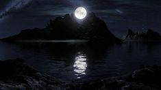 a full moon is seen over an island in the middle of the ocean with rocks