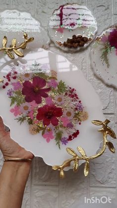 a person holding a plate with flowers on it