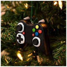 an ornament shaped like a video game controller hanging from a christmas tree