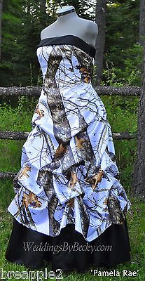 a dress made out of realtree camo, with black and white ruffles