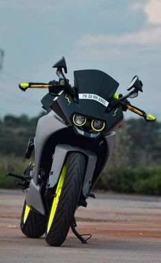 a black and yellow motorcycle parked on the street