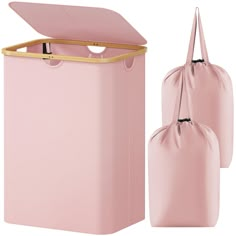 a pink trash can with two bags next to it