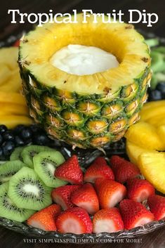 tropical fruit dip with strawberries, kiwis, and bananas on a plate