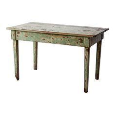 an old wooden table with peeling paint on the top and legs, against a white background