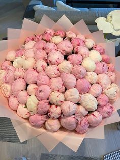 a large bowl filled with lots of pink and white stuff on top of a table