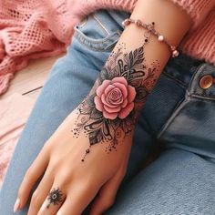 a woman's hand with a rose tattoo on it