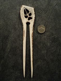 two toothbrushes are next to a penny on a table with black leather surface