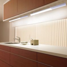 a kitchen with wooden cabinets and white counter tops