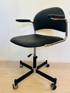 an office chair sitting on top of a hard wood floor