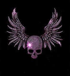 a pink skull with wings on it's chest is lit up in the dark