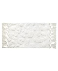 a bath mat with hearts on it and fringes around the edge, in white