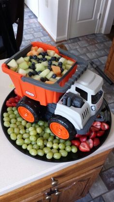 a cake made to look like a tractor with grapes in the front and on the back