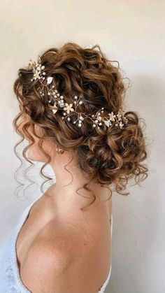 a woman wearing a bridal hair piece with flowers in her hair and pearls on the side