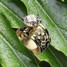 Our 15mm wide Hawaiian engraved tapered ring with 1.50 carat Cubic Zirconia is an original design we made back in 1996. The unique ring has pretty floral scroll cut-out pattern that has been handcrafted in 14K Gold-Glaze Silver. Please choose your ring size available in sizes 5, 6, 7, 8, 9, 10. This Hawaiian ring is sure to delight making a lovely gift for any occasion. Thank you for supporting local Hawaiian designers.  Enjoy free shipping to the continental USA from our Hawaii Factory. We do n Hawaiian Wedding Ring, Hawaii Ring, Hawaiian Ring, Hawaiian Heirloom Jewelry, Hawaii Gift, Heirloom Jewelry, Hawaiian Jewelry, Heirlooms Jewelry, Island Girl