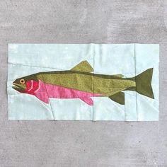 a piece of fabric with a fish on it's side and the bottom part of its body