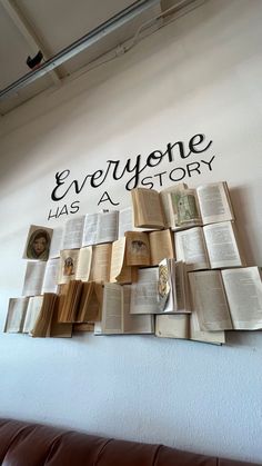 there is a wall with many books on it that says everyone has a story in black lettering