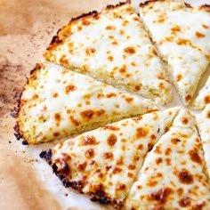 a sliced pizza sitting on top of a wooden cutting board