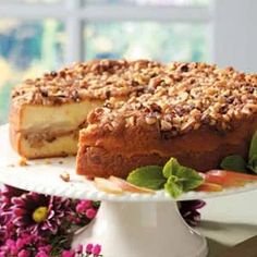 a cake on a plate with flowers in the background