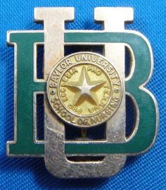 a green and silver belt buckle with a star on the center, in front of a blue background