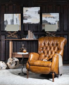 a brown leather chair sitting next to a table