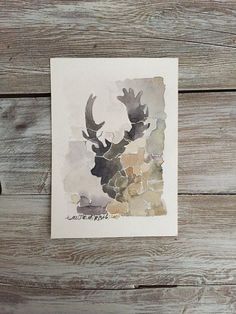 a watercolor painting of a deer's head with antlers in the background