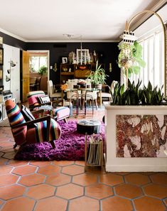 a living room filled with furniture and lots of plants