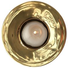 a gold plate with a lit candle in it