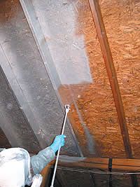 a man in blue gloves is cleaning the ceiling